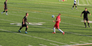 Kingsman (red) on the attack but CSC Mississauga struck 4-0 for open season victory - PHOTO Oleg Kalyadin